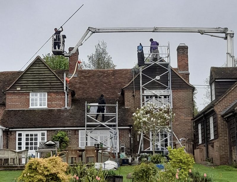 The Roof Moss Cleaners using cherry picker and scaffolding to clean roof safely and professionally in Wootton Bassett, Wiltshire